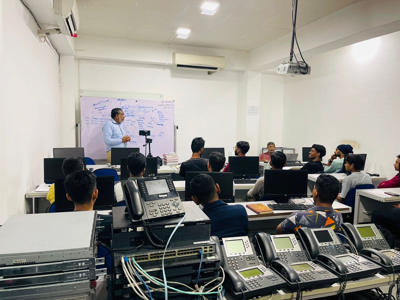 An instructor working with students at WinSYS